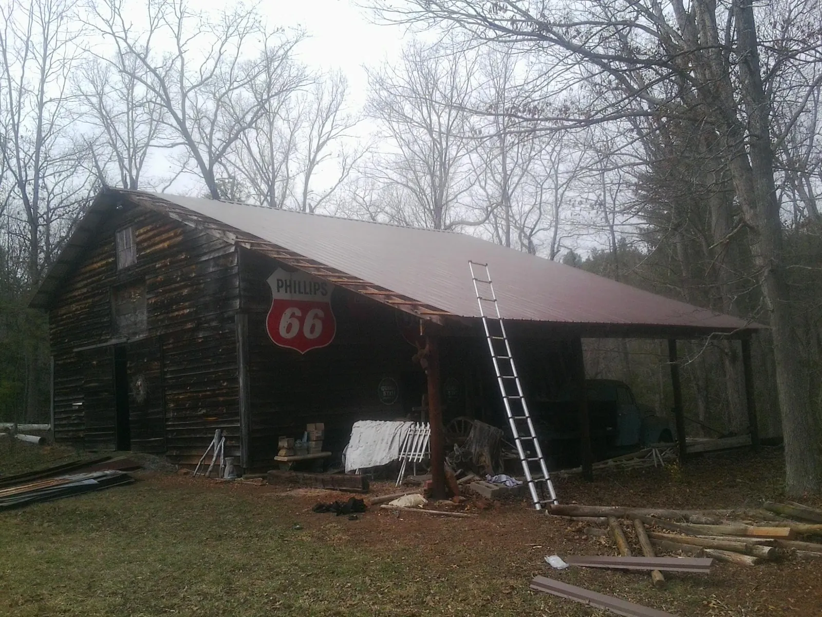 New metal roof on an open sided timber barn with a vintage sign in Montchanin