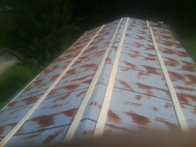 Rusted metal roof panels with new wood purlins before replacement — Storm Damage Roof Repair in Montchanin by Roofing Brothers