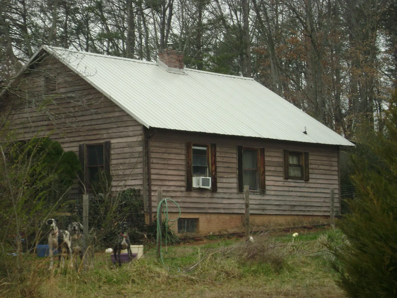 White metal roof on an old wood sided farmhouse, from a Metal Roof Installation job in Montchanin